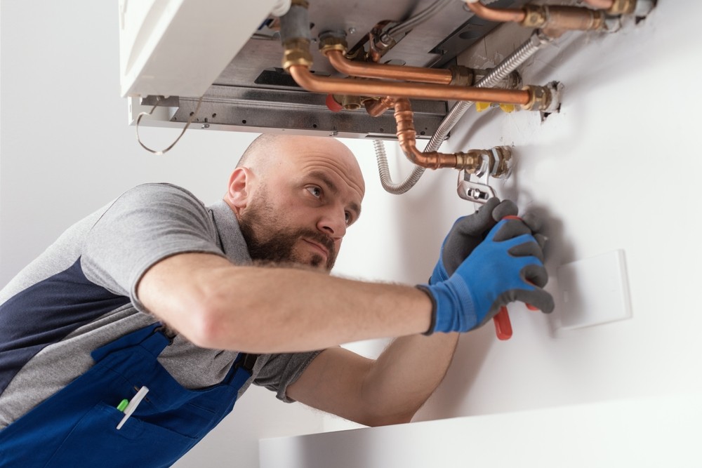 Engineer fixing a boiler